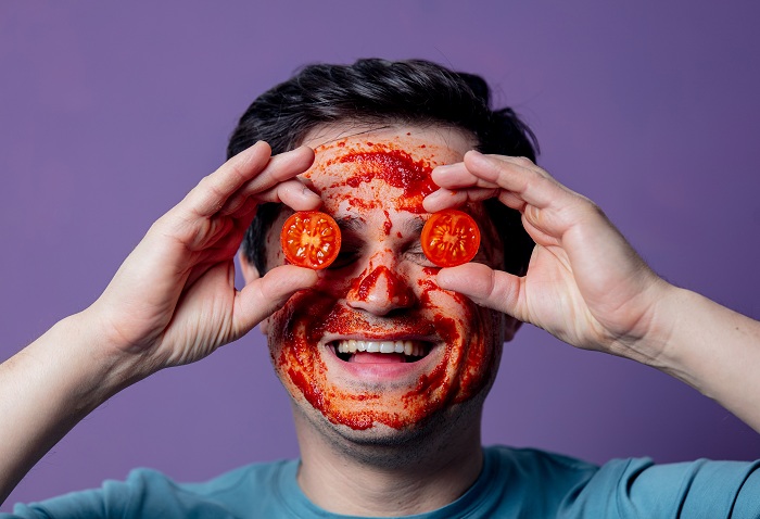 A guy wearing tomato face mask