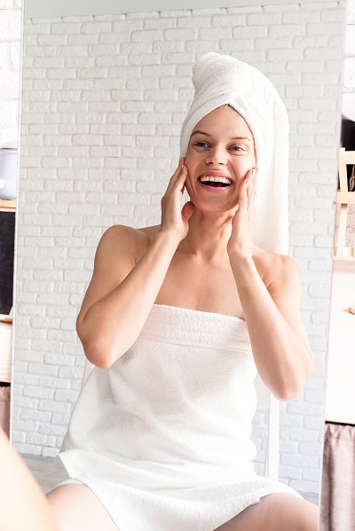 Woman at home happy with skincare results