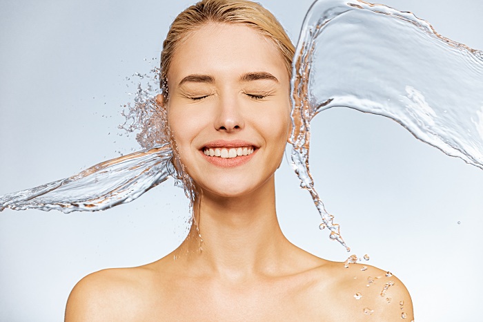 Woman with clear skin on a splash of clean water