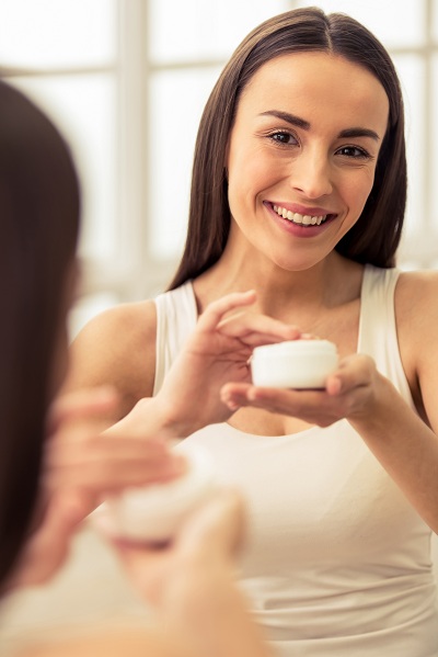 pretty woman on her morning skincare routine