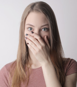 Woman covering her mouth in shock