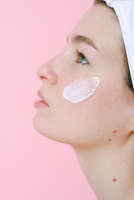 Woman applying face cream