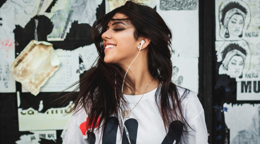 Woman with clear skin wearing earphones
